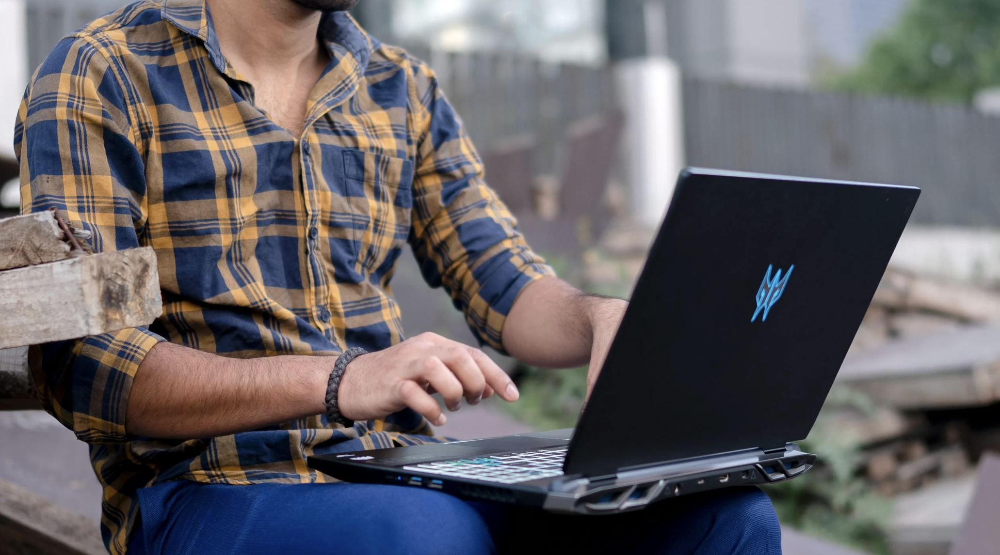 Man typing something on his black laptop