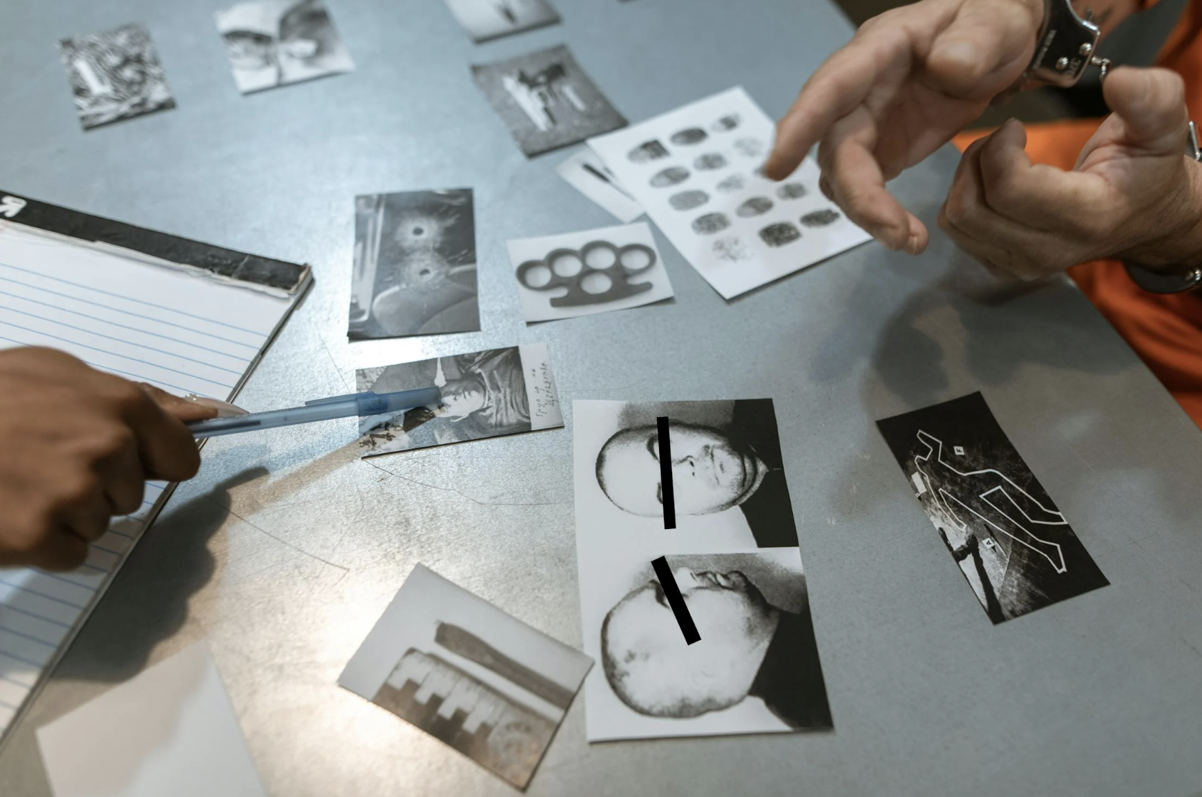 An image of a person pointing to a photo