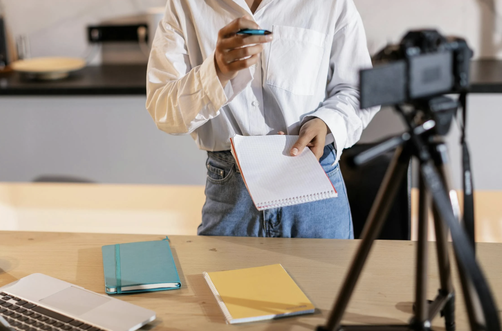 Faceless woman standing in front of a tripod stand